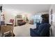 Spacious living room with large windows, plush seating, and a balcony access at 650 S Clinton St # 11B, Denver, CO 80247