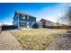 Large fenced backyard with a shed, and a gravel walking path at 2091 Basil St, Strasburg, CO 80136