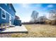 Expansive backyard with a concrete patio, perfect for entertaining and outdoor enjoyment at 2091 Basil St, Strasburg, CO 80136