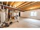 Unfinished basement featuring a water heater, and exposed pipes at 2091 Basil St, Strasburg, CO 80136