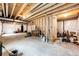 Spacious unfinished basement with exposed beams, prepped for customization at 2091 Basil St, Strasburg, CO 80136