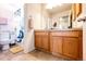Bright bathroom with a double vanity, and tiled floors at 2091 Basil St, Strasburg, CO 80136