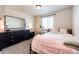 Bedroom features a large dresser, a window, and plush bedding at 2091 Basil St, Strasburg, CO 80136