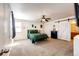 Spacious bedroom features a ceiling fan, carpeted floor and a large closet with sliding door at 2091 Basil St, Strasburg, CO 80136