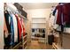 Walk-in closet provides ample storage with built-in shelving and hanging rods at 2091 Basil St, Strasburg, CO 80136