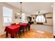 View of dining area featuring hardwood floors, stylish lighting, and an open layout to the living room at 2091 Basil St, Strasburg, CO 80136
