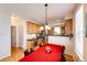 Dining area showcasing hardwood floors, chandelier lighting, and an open connection to the kitchen at 2091 Basil St, Strasburg, CO 80136