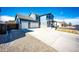A beautiful two-story home with a spacious driveway and two-car garage showing its curb appeal at 2091 Basil St, Strasburg, CO 80136