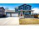 Charming two-story home with a two-car garage and well-maintained front yard and blue siding at 2091 Basil St, Strasburg, CO 80136