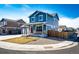 Corner lot home featuring blue siding, a two-car garage, and a well-kept lawn and shrubbery at 2091 Basil St, Strasburg, CO 80136