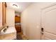 Laundry room equipped with appliances and storage cabinets, adjacent to entry door at 2091 Basil St, Strasburg, CO 80136