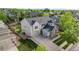 Aerial view of a beautifully landscaped home with a well-maintained lawn and a spacious three-car garage at 6040 Virgil St, Arvada, CO 80403