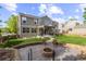 Spacious backyard features a fire pit, a covered patio with a grill, and lush green grass at 6040 Virgil St, Arvada, CO 80403