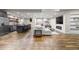 Open basement layout featuring a kitchenette, bar seating, comfortable sofa, and a modern fireplace at 6040 Virgil St, Arvada, CO 80403