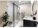 Modern bathroom features a glass-enclosed shower with tile accents and stylish vanity with stone countertops at 6040 Virgil St, Arvada, CO 80403