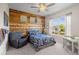 Charming bedroom with a wood accent wall, complemented by a blue bed set and natural light from the window at 6040 Virgil St, Arvada, CO 80403