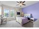 Charming bedroom with a ceiling fan, a cozy bed, and natural light streaming through the windows at 6040 Virgil St, Arvada, CO 80403