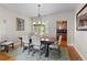 Elegant dining room featuring a large table, upholstered chairs, and stylish decor at 6040 Virgil St, Arvada, CO 80403