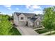 Beautiful two-story home featuring a well-manicured lawn, stone accents, and a two-car garage at 6040 Virgil St, Arvada, CO 80403