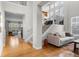 Bright open foyer featuring hardwood floors, staircase with dark metal railing, and multiple windows at 6040 Virgil St, Arvada, CO 80403