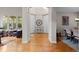 Spacious entry way showcasing gleaming hardwood floors, white pillars and a clear view into other living spaces at 6040 Virgil St, Arvada, CO 80403