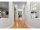 Hallway with gleaming hardwood floors, white trim, and views of the home's architecture at 6040 Virgil St, Arvada, CO 80403