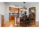 Charming kitchen with an island, stainless steel appliances, dark countertops, and wooden cabinets at 6040 Virgil St, Arvada, CO 80403