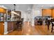 Well-lit kitchen with hardwood floors, a large island, pendant lighting, and modern stainless steel appliances at 6040 Virgil St, Arvada, CO 80403