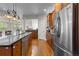 Spacious kitchen with an island, wood cabinets, stainless steel appliances, and an open design at 6040 Virgil St, Arvada, CO 80403