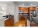 Bright kitchen with stainless steel appliances, wood cabinets, and ample countertop space at 6040 Virgil St, Arvada, CO 80403