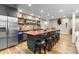 Basement kitchenette featuring a refrigerator, bar seating, and a stylish backsplash for a modern look at 6040 Virgil St, Arvada, CO 80403
