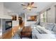 Open-concept living room with a fireplace that offers a view into the kitchen and dining area at 6040 Virgil St, Arvada, CO 80403