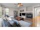 Cozy living room with a fireplace, ceiling fan, stylish rug, and comfortable seating at 6040 Virgil St, Arvada, CO 80403