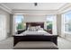 Beautiful main bedroom featuring a tray ceiling, carpet flooring, and large windows offering scenic views at 6040 Virgil St, Arvada, CO 80403