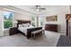Elegant main bedroom boasts a tray ceiling, a ceiling fan, and large windows for ample natural light at 6040 Virgil St, Arvada, CO 80403