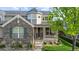 Inviting covered front porch displaying brick accents, well-kept landscaping, and a 'Welcome' sign at 6040 Virgil St, Arvada, CO 80403