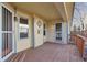 Covered back porch with wood flooring, natural light, and protected entryways offers relaxing outdoor living at 12776 Yates Cir, Broomfield, CO 80020