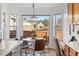 Breakfast nook with large windows overlooking fenced backyard and modern light fixture at 12776 Yates Cir, Broomfield, CO 80020