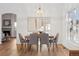 Dining room featuring a wood table, six gray chairs, and modern lighting fixture at 12776 Yates Cir, Broomfield, CO 80020