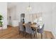 Bright dining area featuring modern light fixture, wood floors, and neutral decor at 12776 Yates Cir, Broomfield, CO 80020