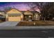 Charming single Gathering home featuring a two-car garage, stone accents, and a well-maintained front yard at 12776 Yates Cir, Broomfield, CO 80020