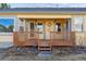 Charming covered front porch with wood railing, creating a welcoming entrance to the home at 12776 Yates Cir, Broomfield, CO 80020