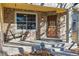 Inviting front porch featuring stone accents, a hanging swing, and a secure front door at 12776 Yates Cir, Broomfield, CO 80020