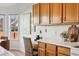 Kitchen nook with built in desk, wood cabinets, and view of the backyard at 12776 Yates Cir, Broomfield, CO 80020