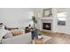 Cozy living room featuring a fireplace, neutral furniture, and light wood flooring at 12776 Yates Cir, Broomfield, CO 80020