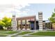 Modern brick community center showcasing large windows, prominent entrance, and manicured landscaping at 10712 Dayton Way, Commerce City, CO 80640