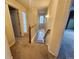 Upstairs hallway with carpet, a window, and doors to bedrooms and bathrooms at 10712 Dayton Way, Commerce City, CO 80640