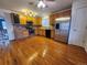 Well-lit kitchen features stainless steel appliances, wooden cabinets, and hardwood floors at 10712 Dayton Way, Commerce City, CO 80640