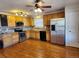 Well-lit kitchen with stainless steel appliances, hardwood floors, and stylish backsplash at 10712 Dayton Way, Commerce City, CO 80640