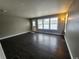 Bright living room with hardwood floors, large windows, and a door to the outside at 10712 Dayton Way, Commerce City, CO 80640